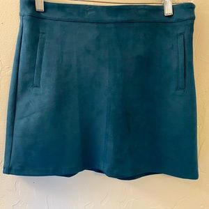 Mini suede-like skirt in Pine color in size medium